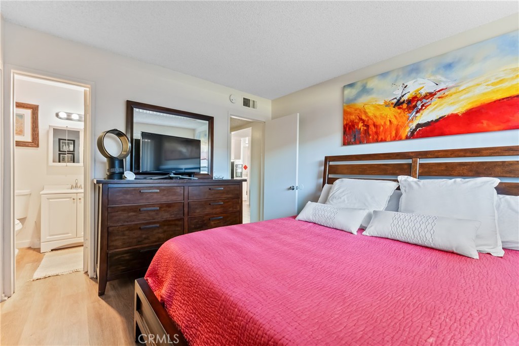 4641 Arlington Avenue Riverside, CA 92504 - Photo 22 of 33 a bedroom with a bed and a flat screen tv