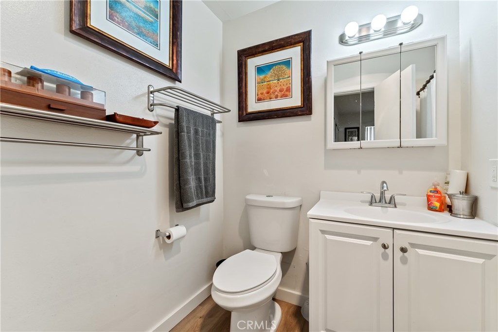4641 Arlington Avenue Riverside, CA 92504 - Photo 23 of 33 a bathroom with a toilet sink and mirror