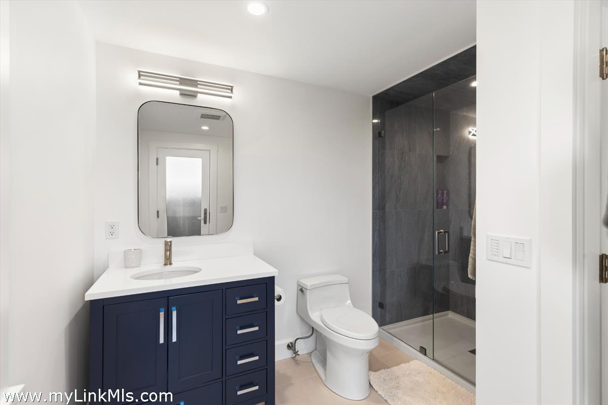 3 Tautemo Way Nantucket, MA 02554 - Photo 38 of 57 a bathroom with a sink vanity mirror and toilet