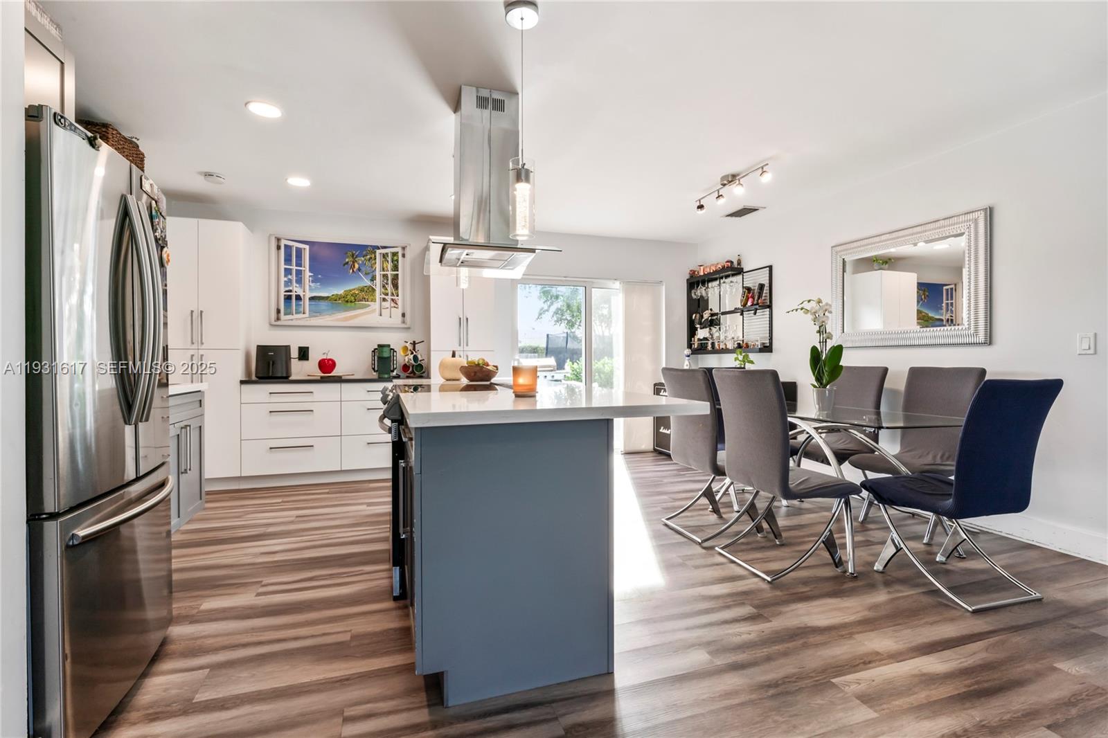 9612 Wyoming Court Boca Raton, FL 33434 - Photo 11 of 44 a kitchen with stainless steel appliances kitchen island granite countertop a refrigerator a stove a sink and white cabinets with wooden floor