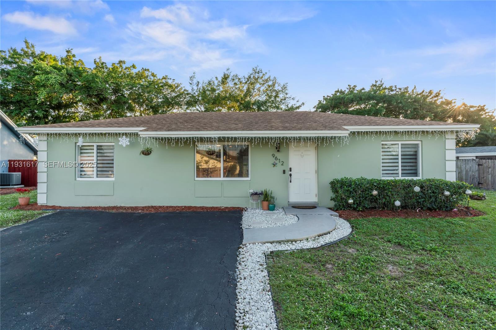 9612 Wyoming Court Boca Raton, FL 33434 - Photo 4 of 44 a view of a house with a yard and potted plants