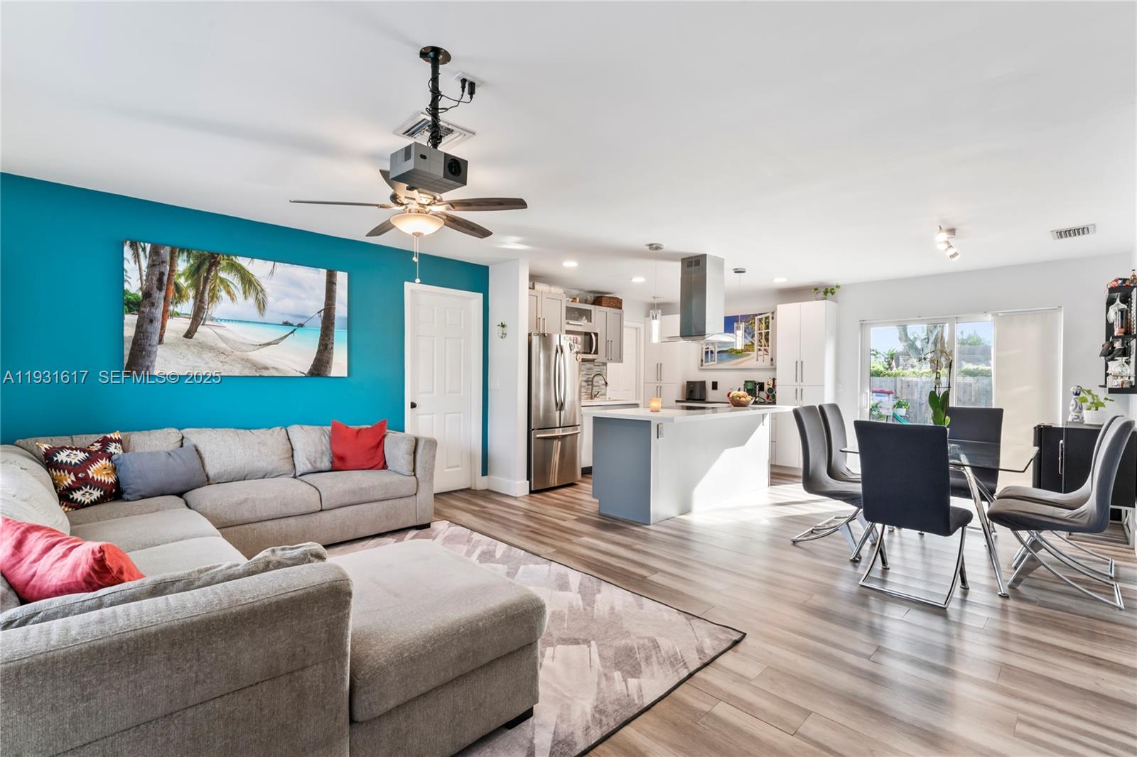 9612 Wyoming Court Boca Raton, FL 33434 - Photo 6 of 44 a living room with furniture kitchen view and a chandelier