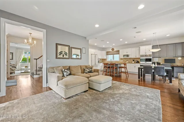 a living room with furniture and kitchen view