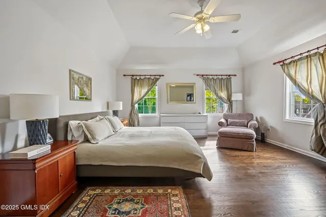 a bedroom with a bed couch and a window