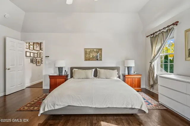 a bedroom with a large bed and a large window