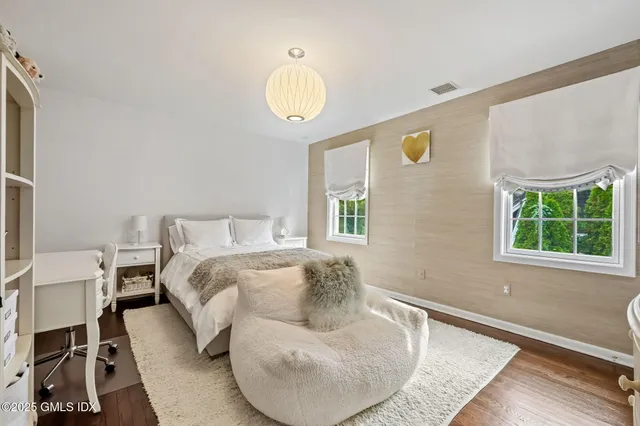 a bed room with a bed and a chair