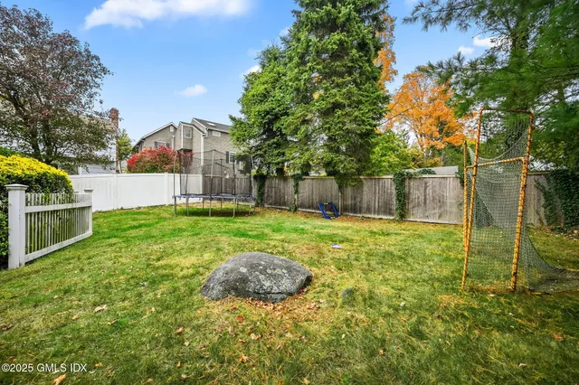 a view of a house with brick walls and flower plants