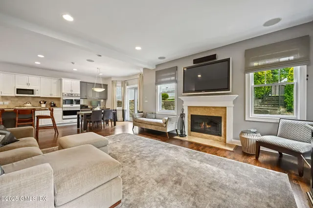 a living room with furniture fireplace and flat screen tv