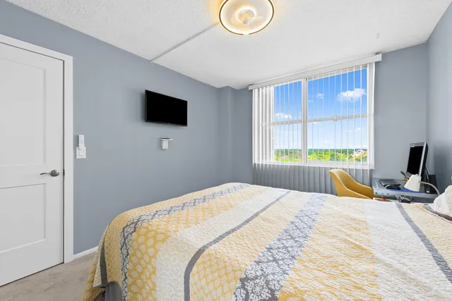 a bedroom with a bed and a flat screen tv