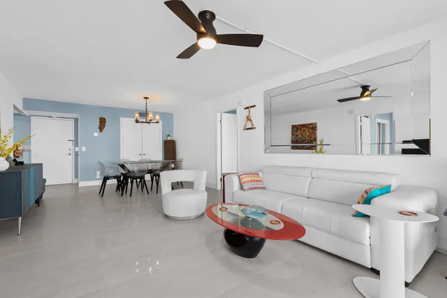 a living room with furniture and kitchen view