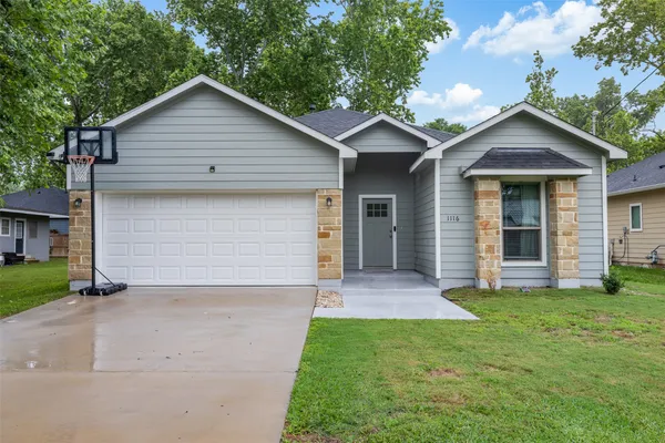 a front view of a house with a yard and garage