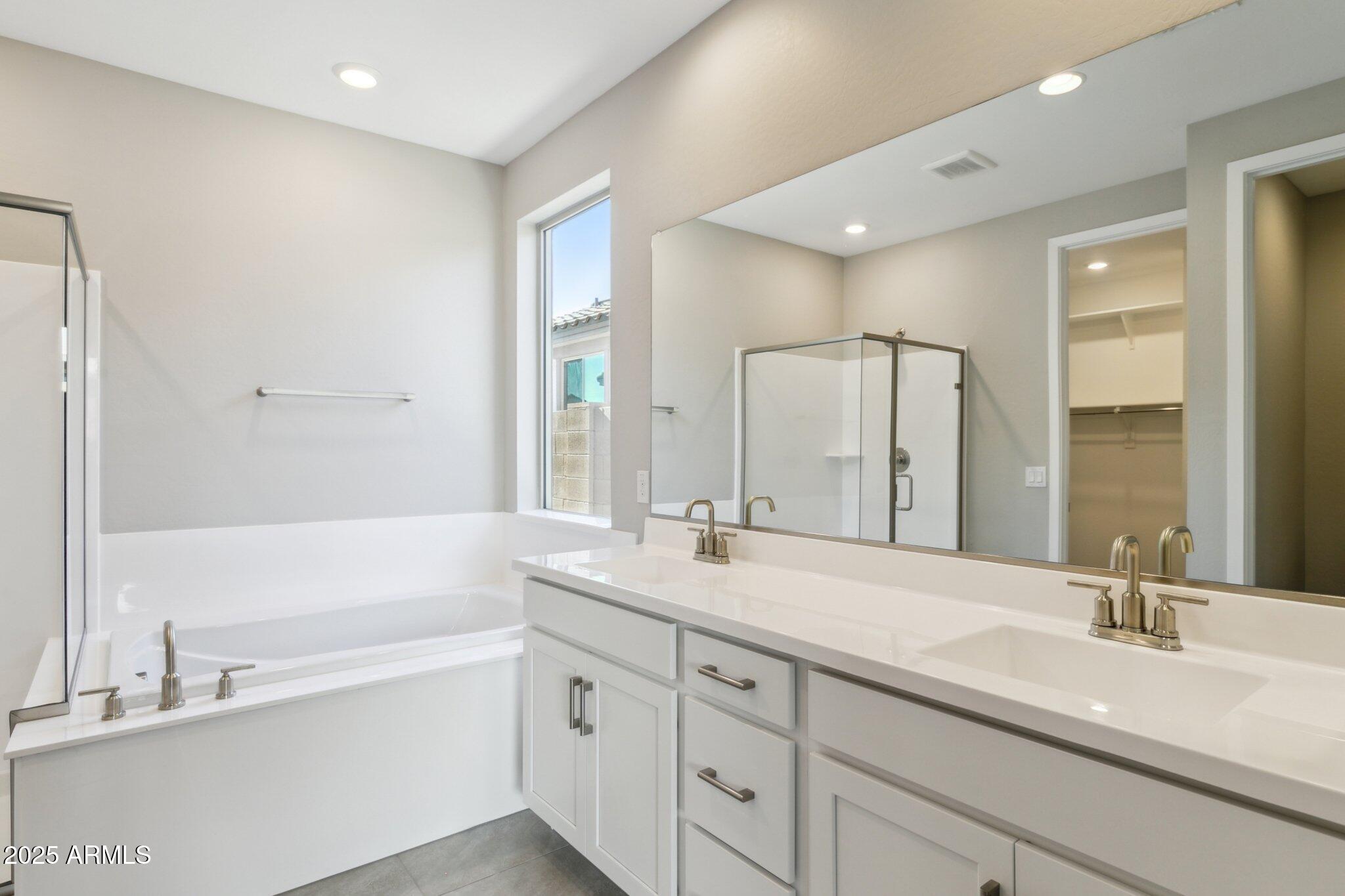 14742 West Soft Wind Drive Surprise, AZ 85387 - Photo 12 of 26 a bathroom with a double vanity sink mirror double and bathtub