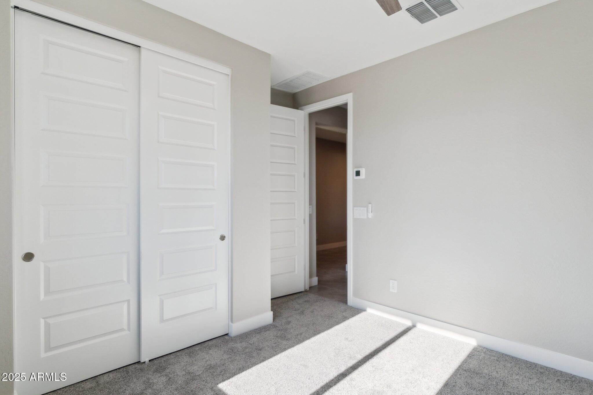 14742 West Soft Wind Drive Surprise, AZ 85387 - Photo 13 of 26 an empty room with closet