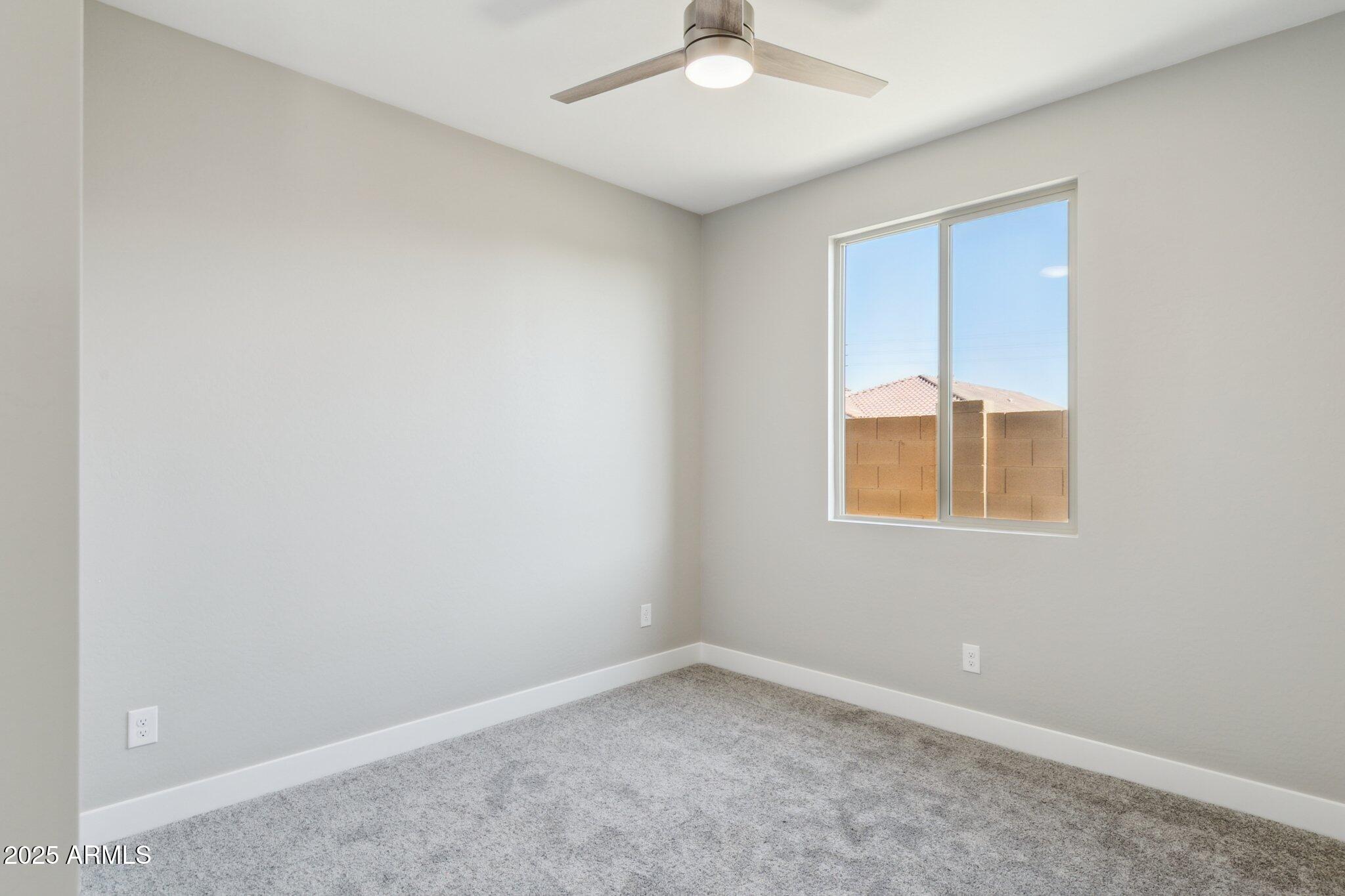 14742 West Soft Wind Drive Surprise, AZ 85387 - Photo 14 of 26 an empty room with a window