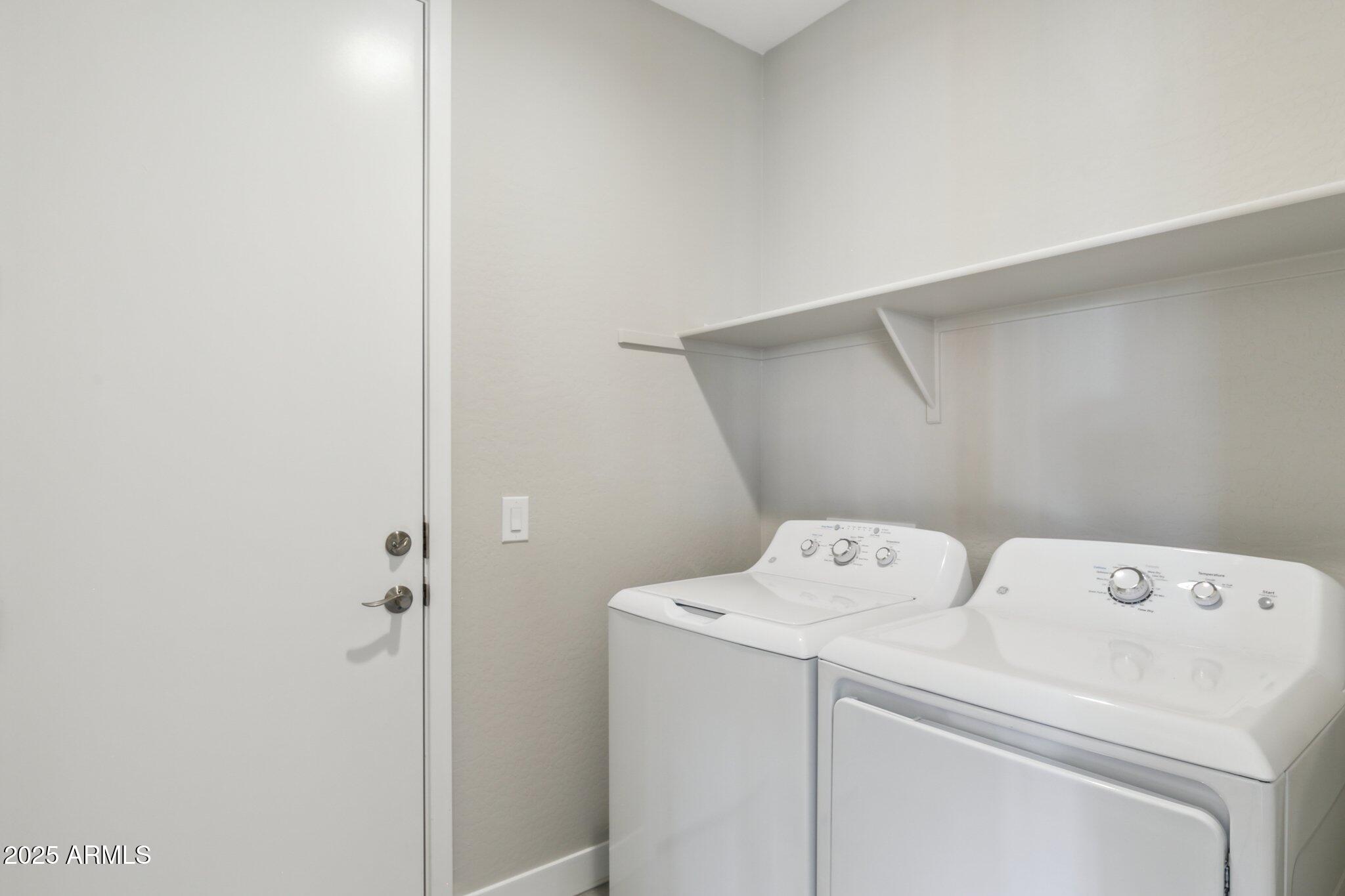14742 West Soft Wind Drive Surprise, AZ 85387 - Photo 18 of 26 a utility room with dryer and washer