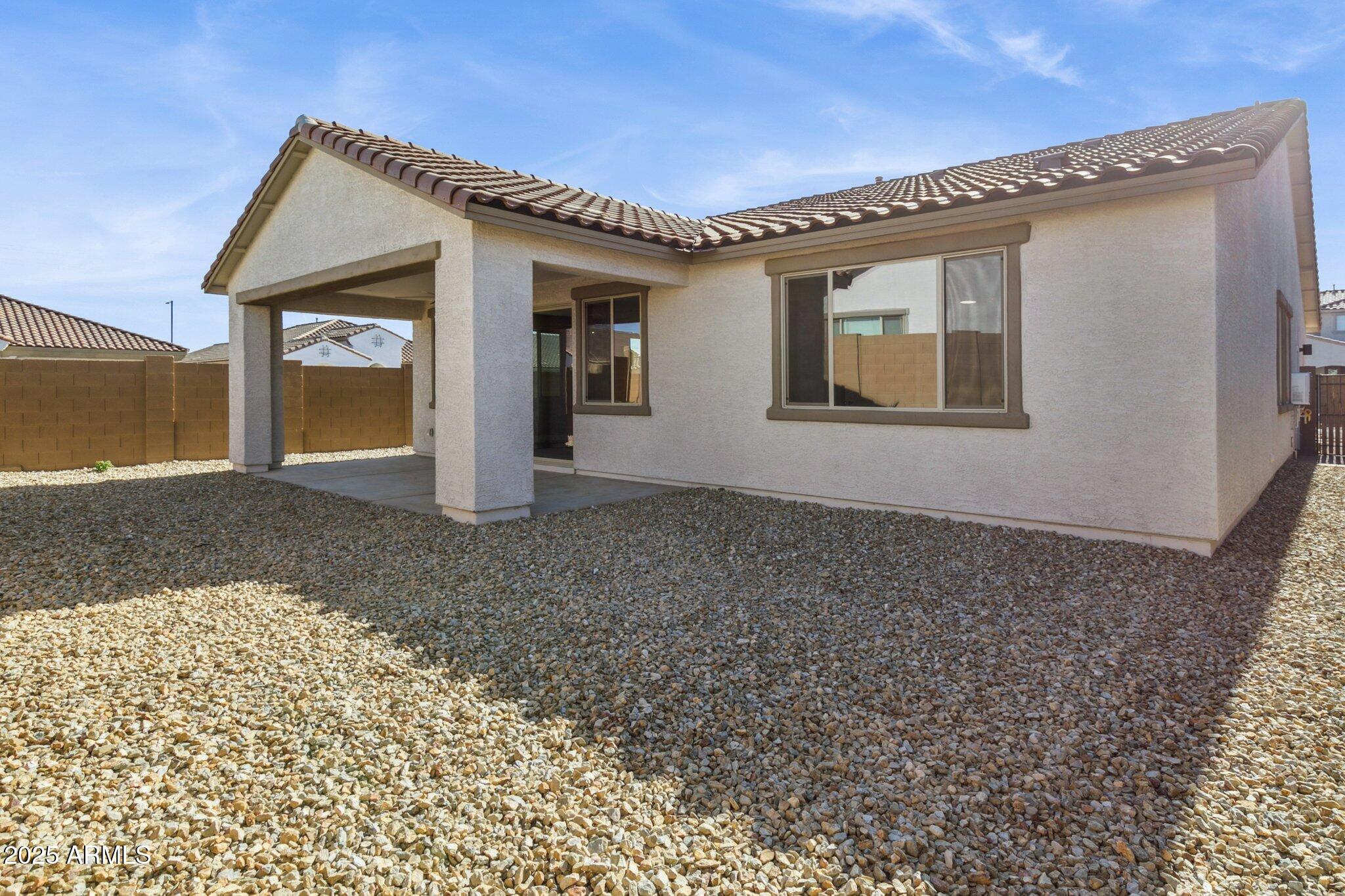 14742 West Soft Wind Drive Surprise, AZ 85387 - Photo 2 of 26 a front view of a house with a garden
