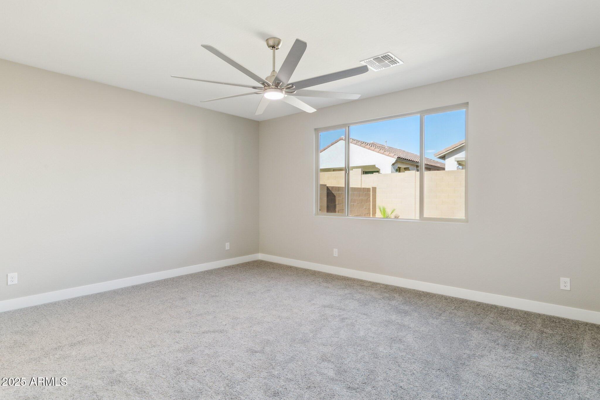 14742 West Soft Wind Drive Surprise, AZ 85387 - Photo 22 of 26 an empty room with a window and ceiling fan