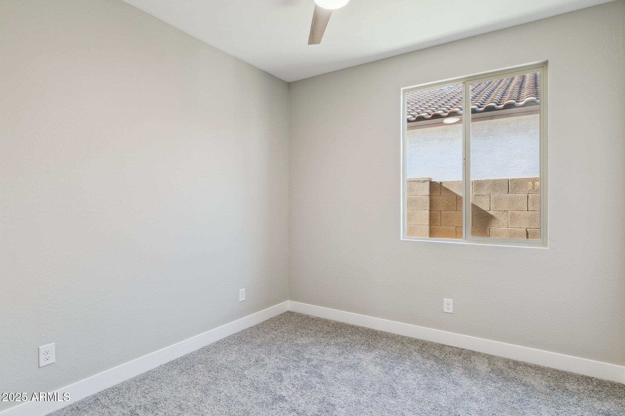 14742 West Soft Wind Drive Surprise, AZ 85387 - Photo 24 of 26 an empty room with a window