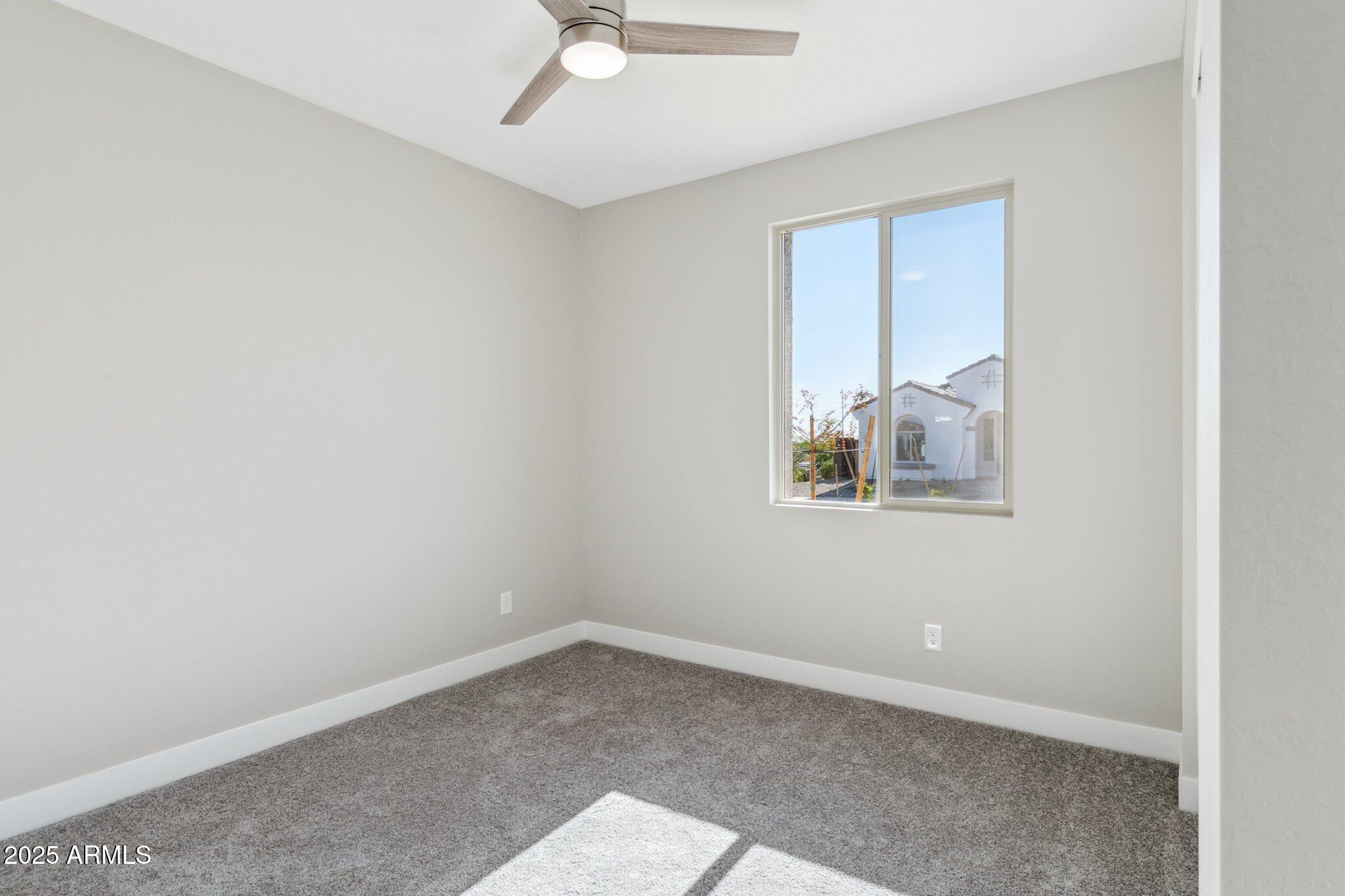 14742 West Soft Wind Drive Surprise, AZ 85387 - Photo 26 of 26 an empty room with a window