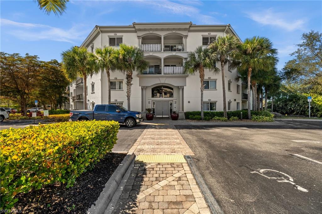 1100 Pine Ridge Road, Unit B103 Naples, FL 34108 - Photo 30 of 38 a front view of a house with a yard