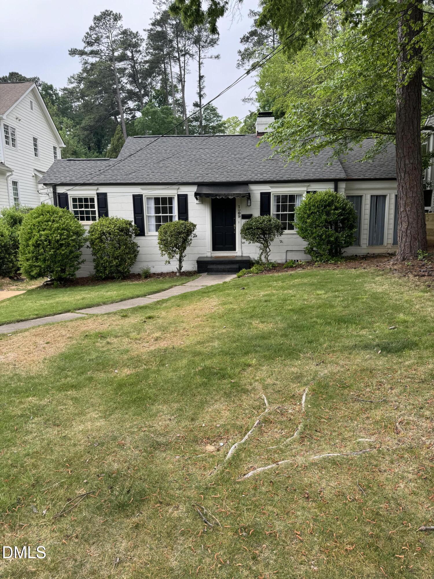 1009 Canterbury Road Raleigh, NC 27607 - Photo 18 of 31 a front view of a house with a garden