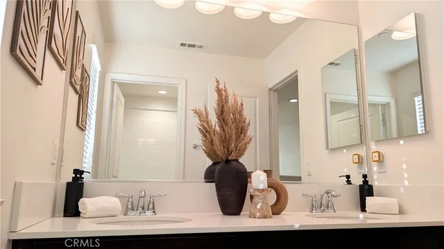 a view of a bathroom with a sink a mirror and a bathtub