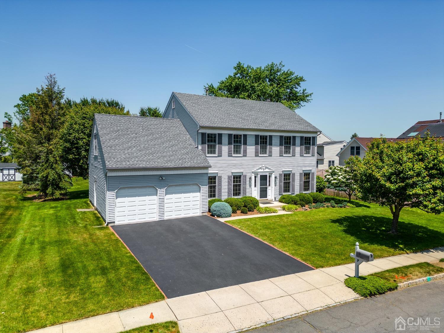 9 Dickinson Road Kendall Park, NJ 08824 - Photo 1 of 34 a front view of a house with a yard
