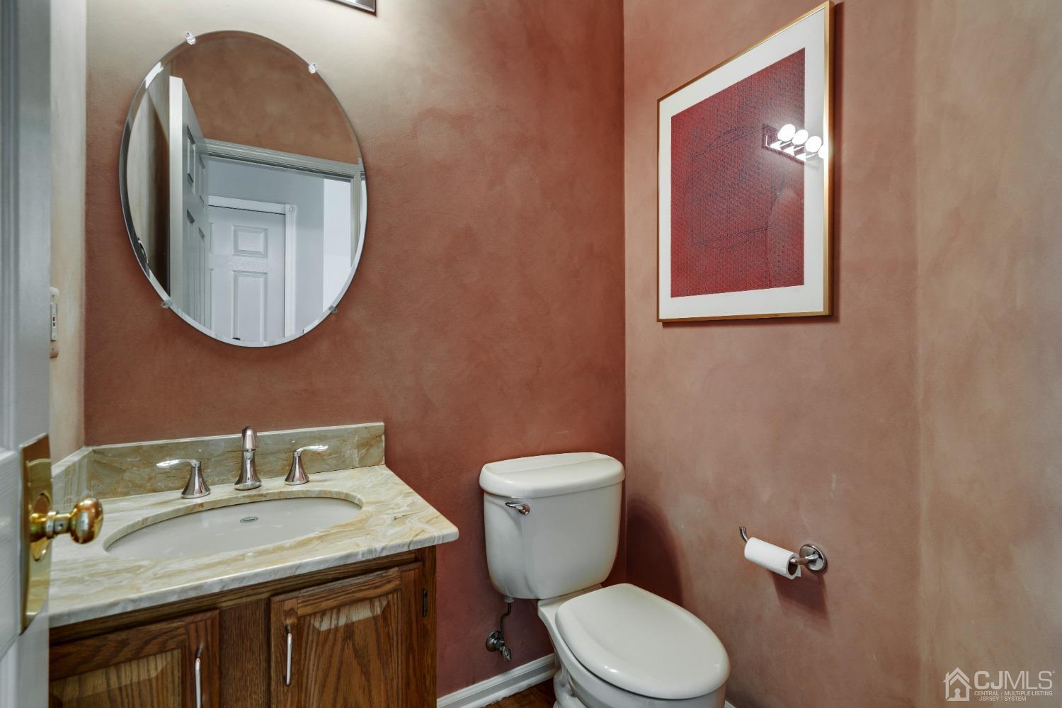 9 Dickinson Road Kendall Park, NJ 08824 - Photo 13 of 34 a bathroom with a toilet a sink and mirror