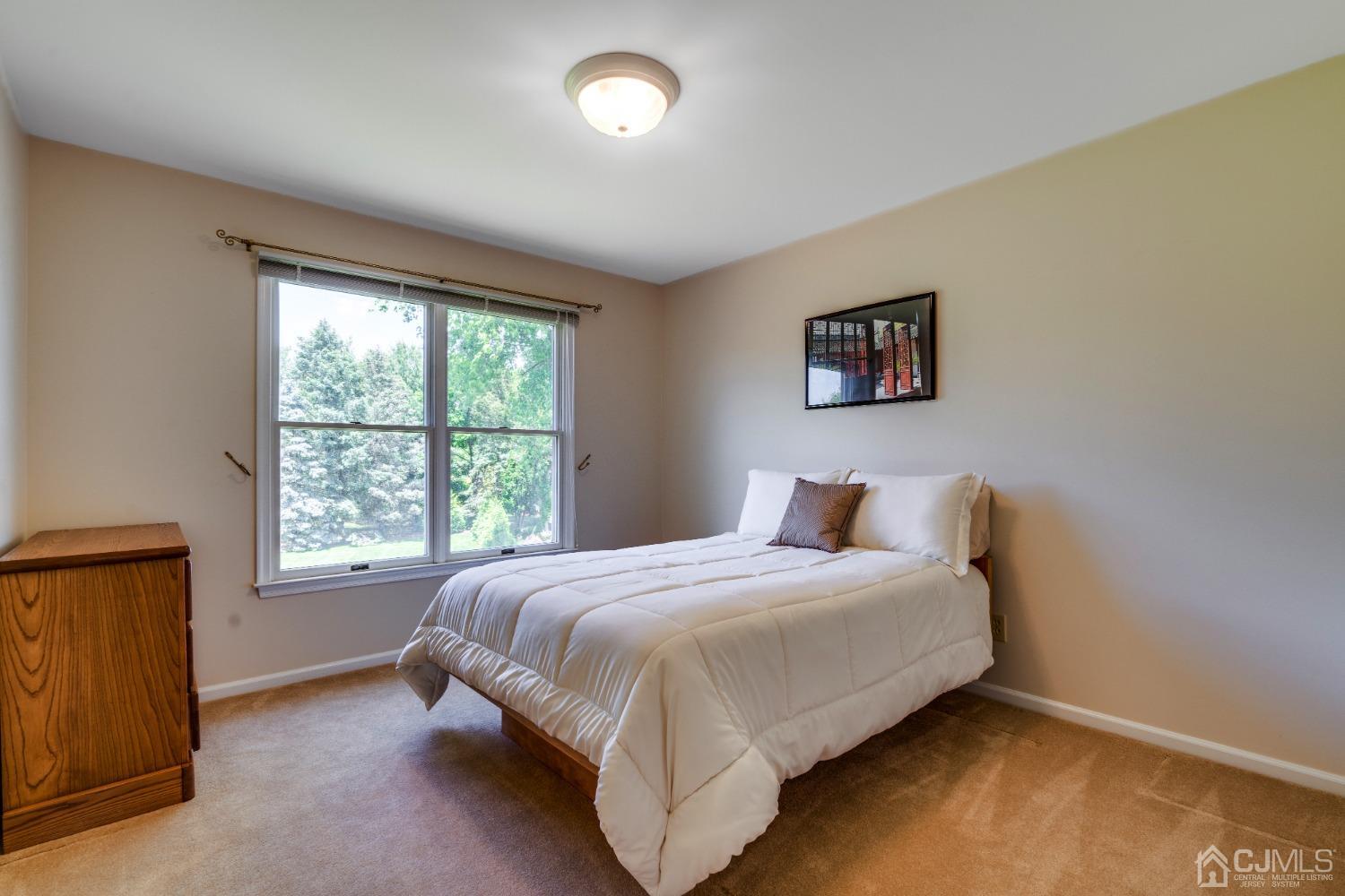 9 Dickinson Road Kendall Park, NJ 08824 - Photo 16 of 34 a bedroom with a bed and a window