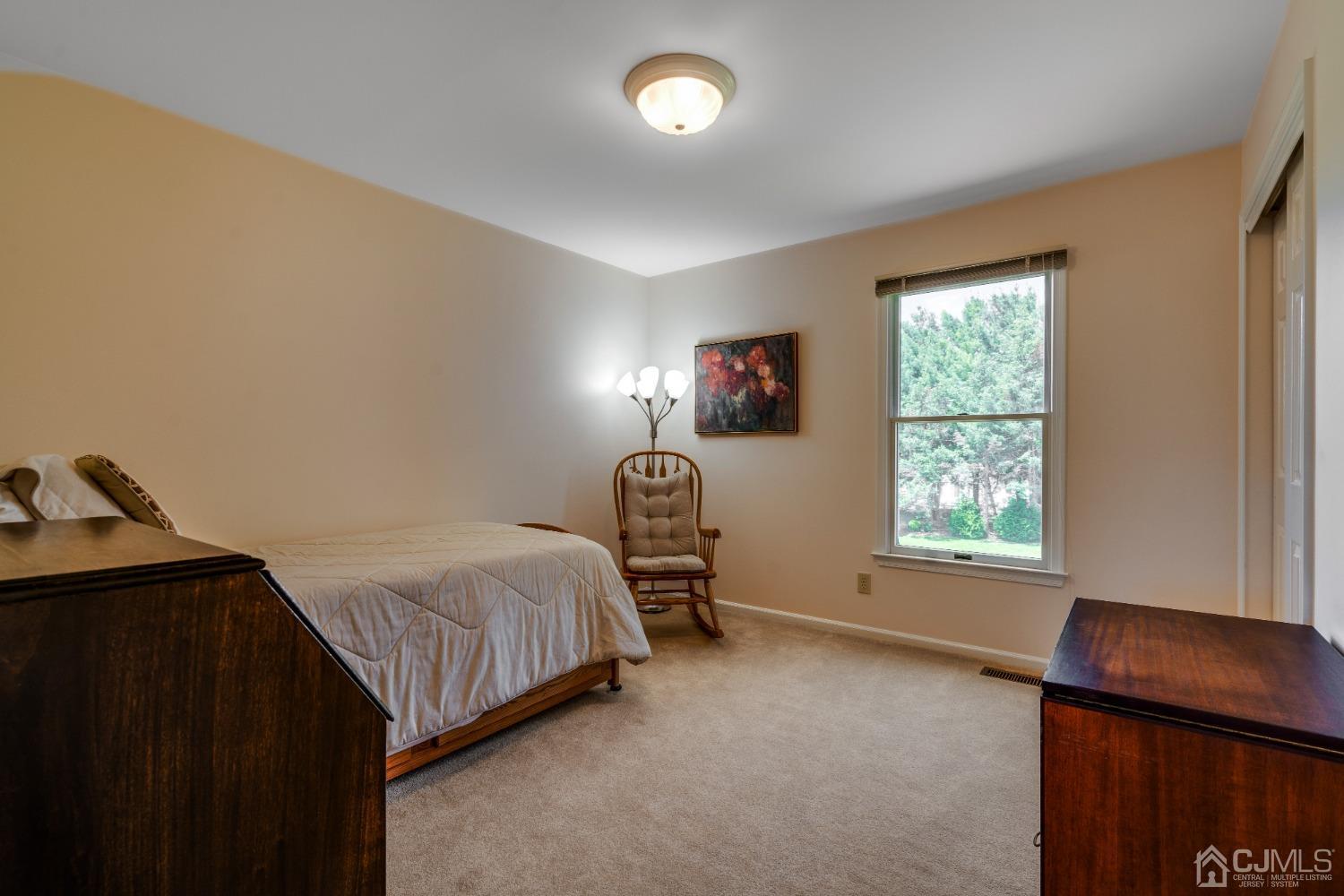 9 Dickinson Road Kendall Park, NJ 08824 - Photo 17 of 34 a bedroom with a bed and a window
