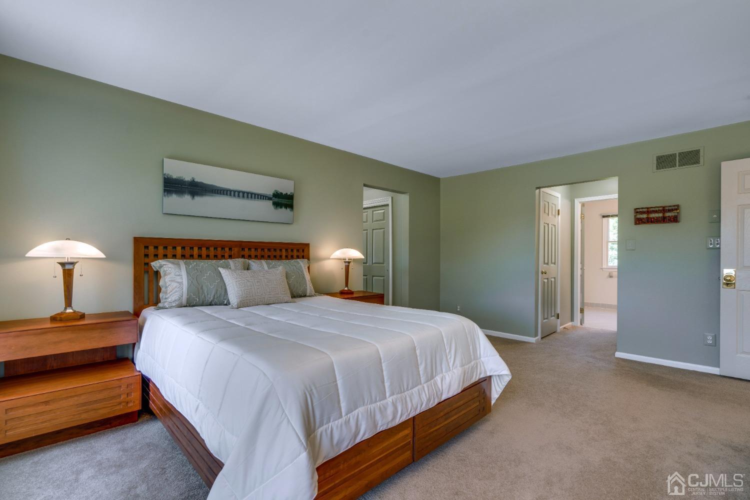 9 Dickinson Road Kendall Park, NJ 08824 - Photo 20 of 34 a bedroom with a bed and a lamp