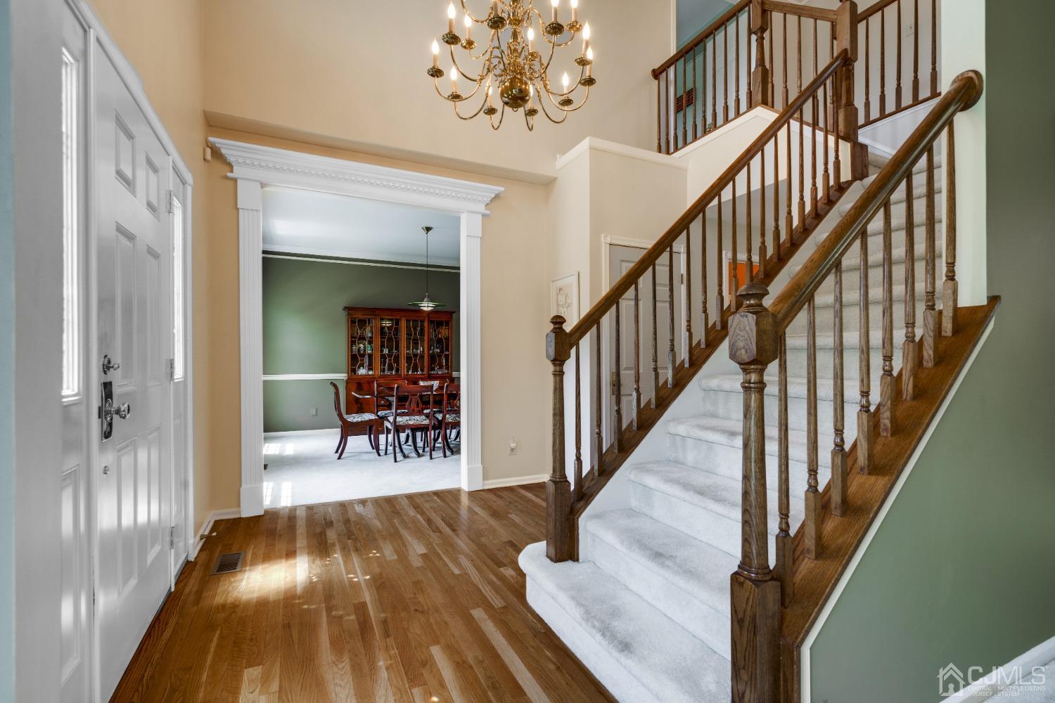 9 Dickinson Road Kendall Park, NJ 08824 - Photo 2 of 34 a view of a hallway with wooden floor and staircase