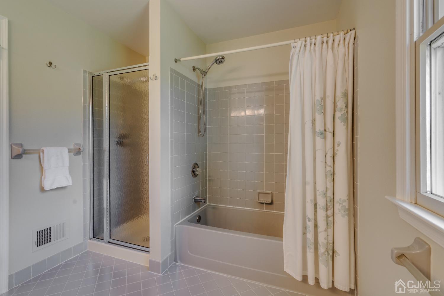 9 Dickinson Road Kendall Park, NJ 08824 - Photo 22 of 34 a bathroom with a shower and a bath tub