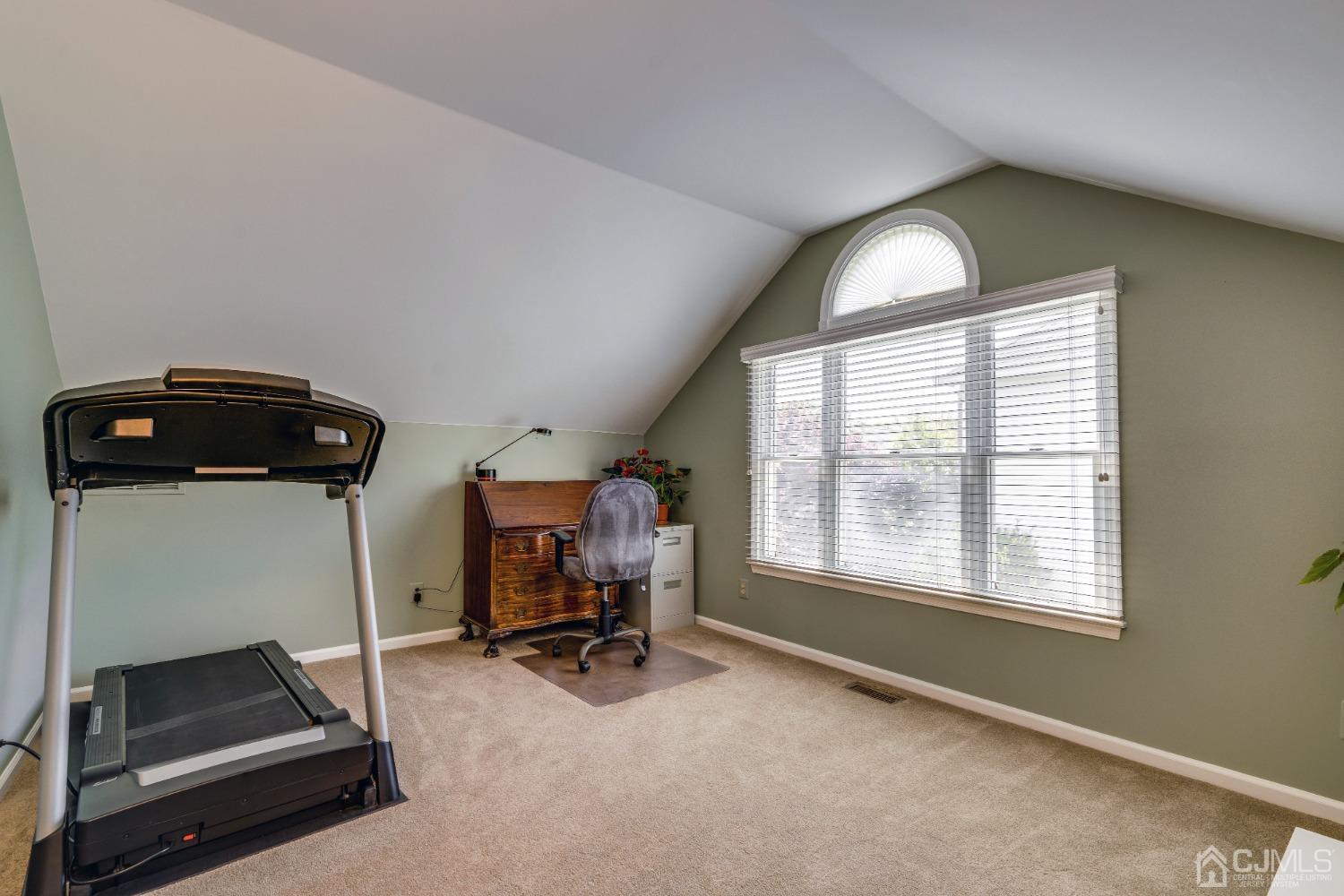9 Dickinson Road Kendall Park, NJ 08824 - Photo 23 of 34 a view of a room with gym equipment and windows
