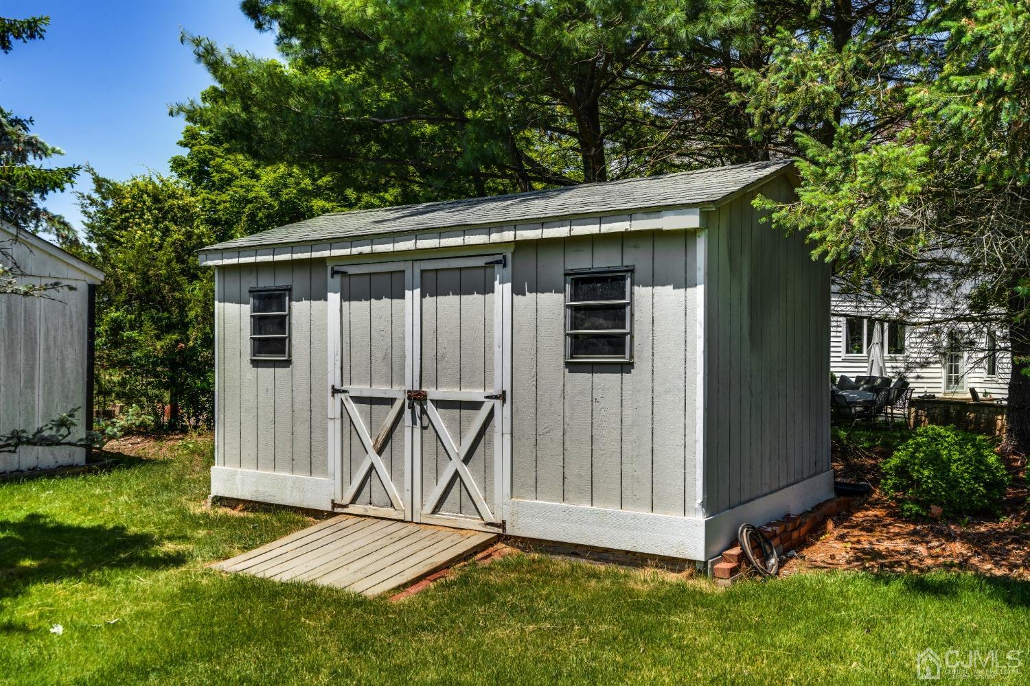 9 Dickinson Road Kendall Park, NJ 08824 - Photo 26 of 34 a view of backyard with a small cabin and a chair