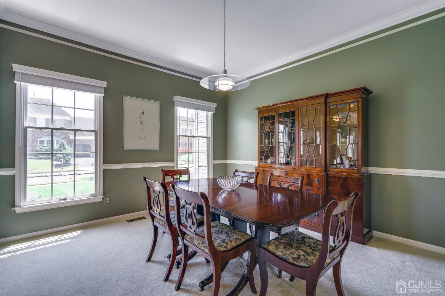 9 Dickinson Road Kendall Park, NJ 08824 - Photo 3 of 34 a dining room with furniture a chandelier and window