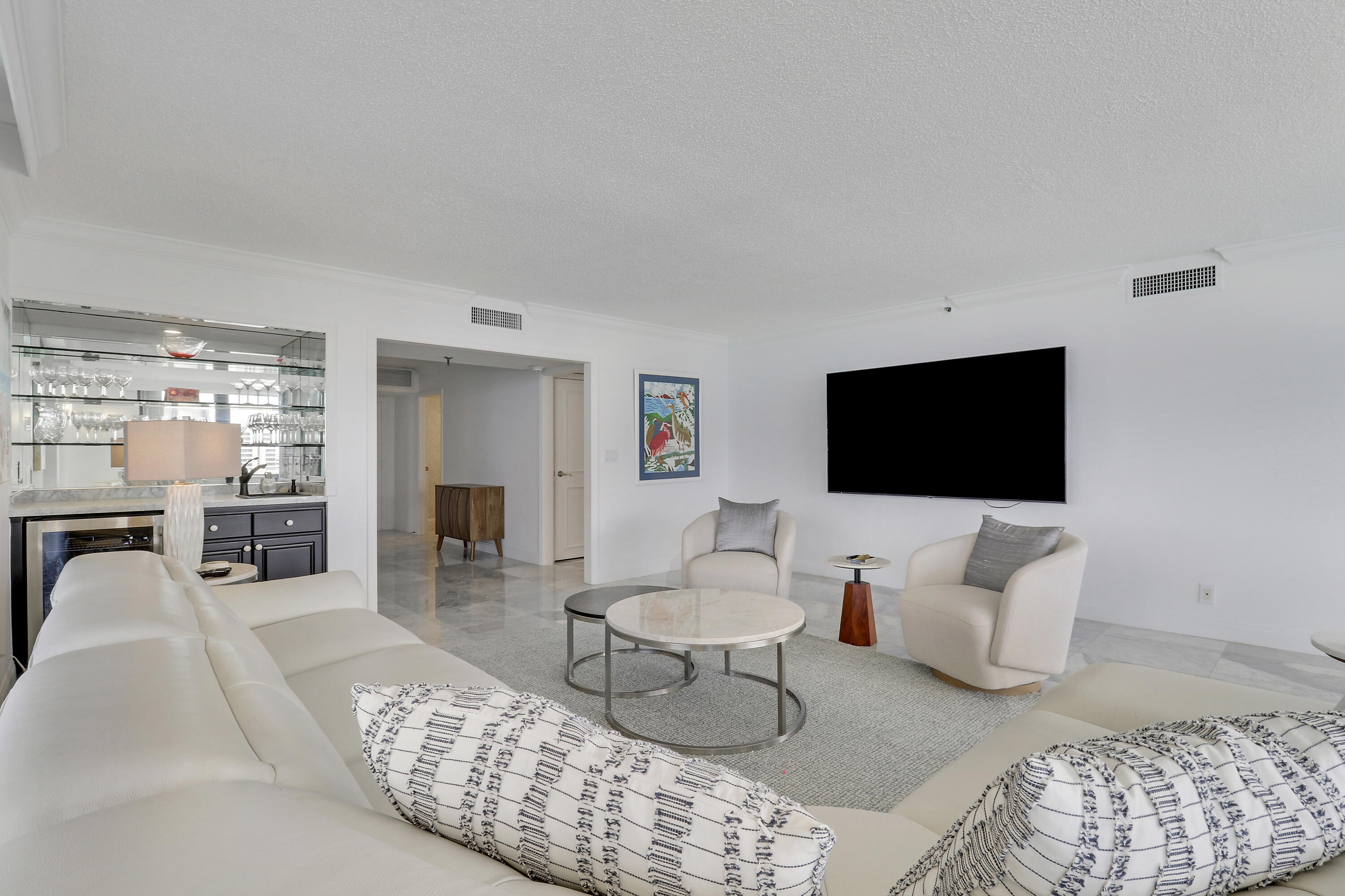 5380 North Ocean Drive, Unit 22J Riviera Beach, FL 33404 - Photo 11 of 53 a living room with furniture and a flat screen tv