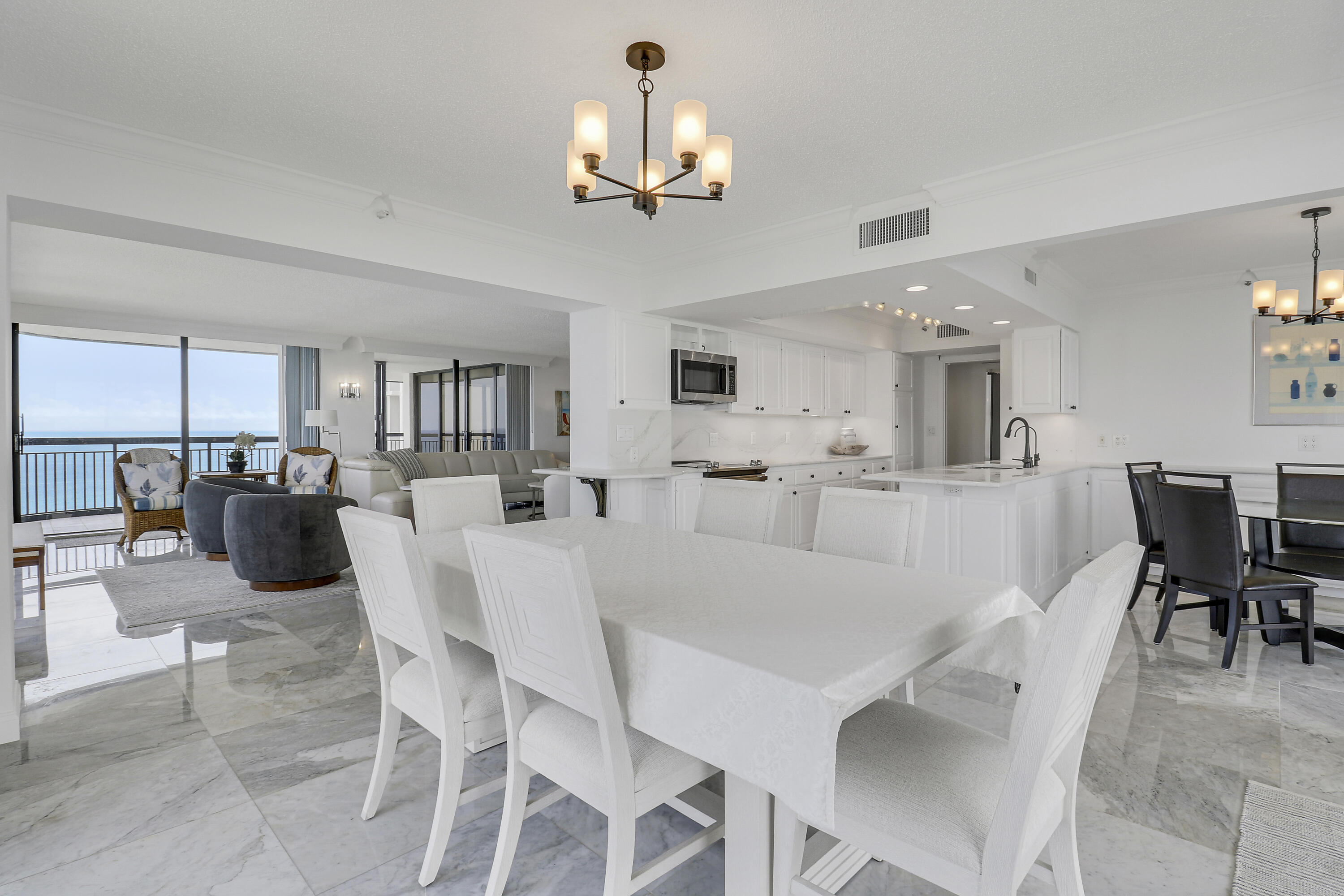 5380 North Ocean Drive, Unit 22J Riviera Beach, FL 33404 - Photo 17 of 53 a view of a dining room with furniture and chandelier