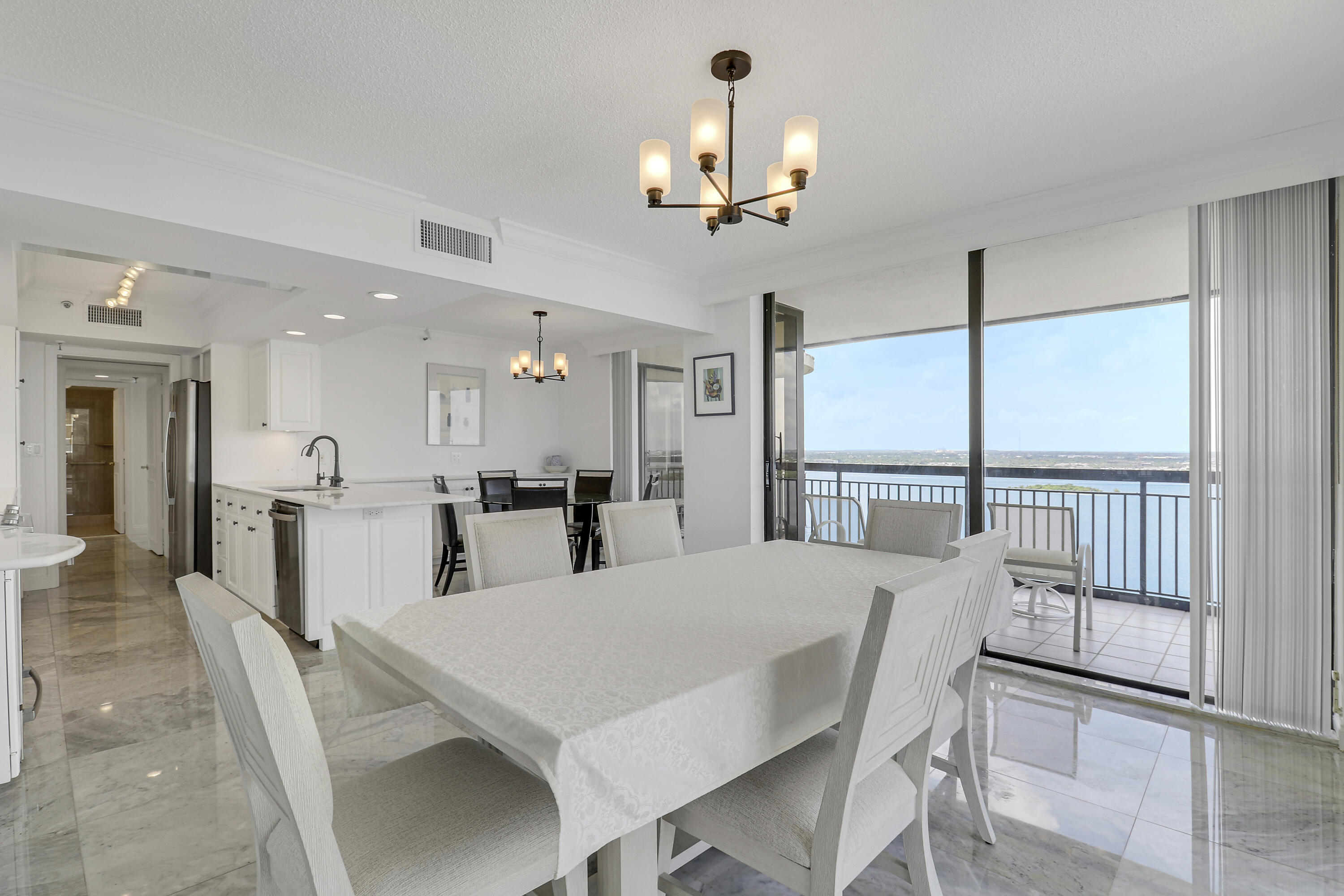 5380 North Ocean Drive, Unit 22J Riviera Beach, FL 33404 - Photo 18 of 53 a view of a dining room with furniture large window and chandelier
