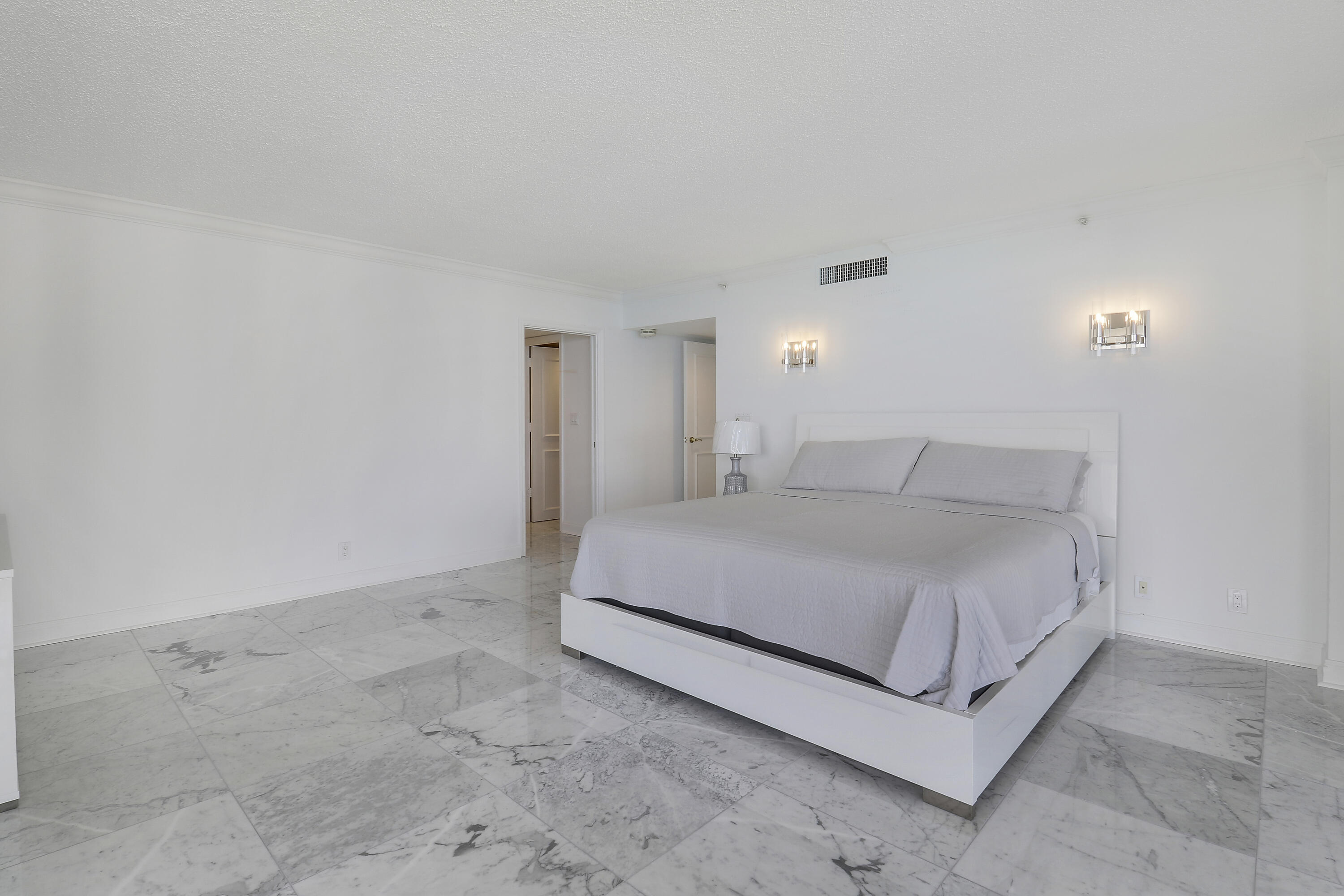 5380 North Ocean Drive, Unit 22J Riviera Beach, FL 33404 - Photo 25 of 53 a spacious bedroom with a bed and a night stand