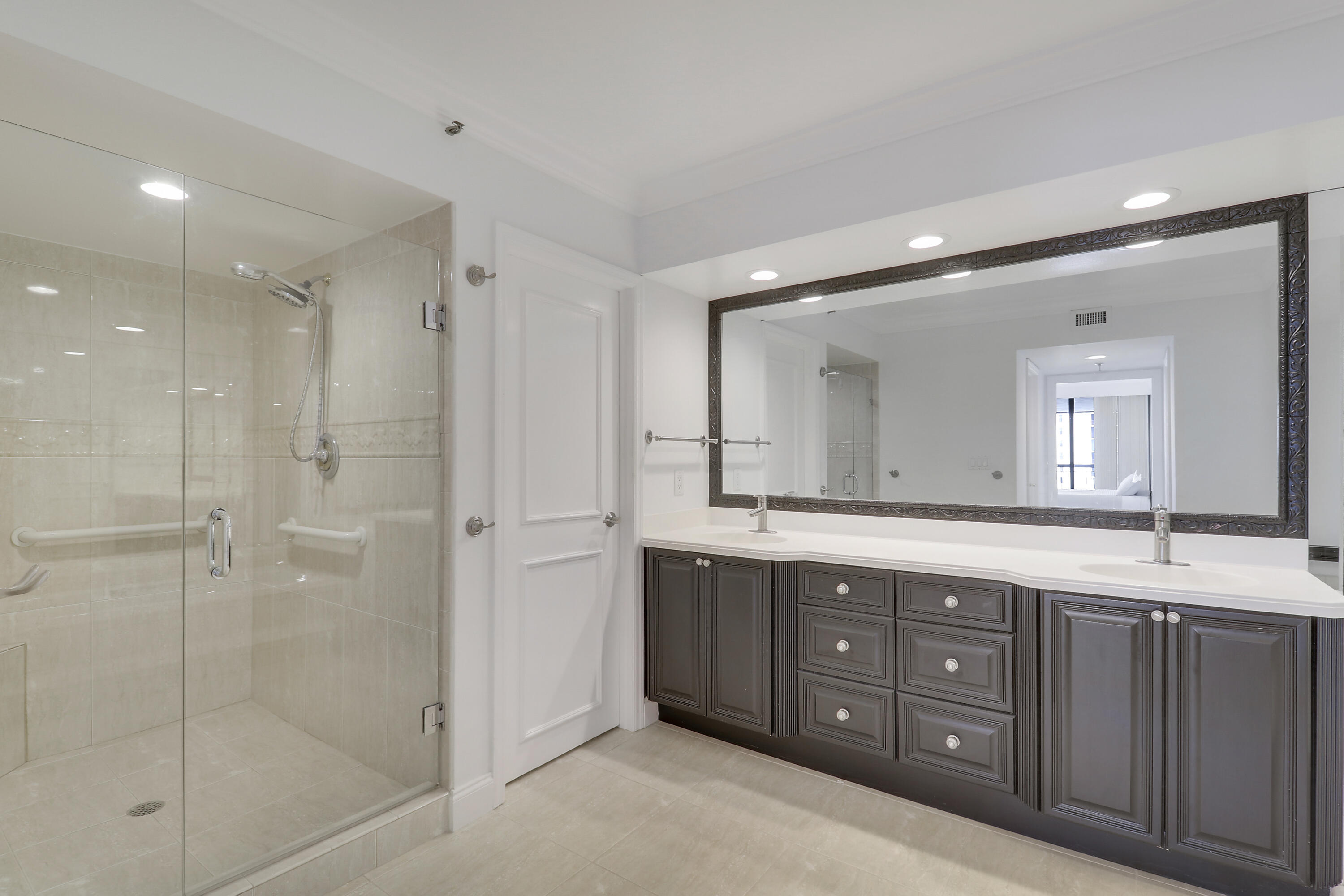 5380 North Ocean Drive, Unit 22J Riviera Beach, FL 33404 - Photo 30 of 53 a spacious bathroom with a shower sink double and mirror