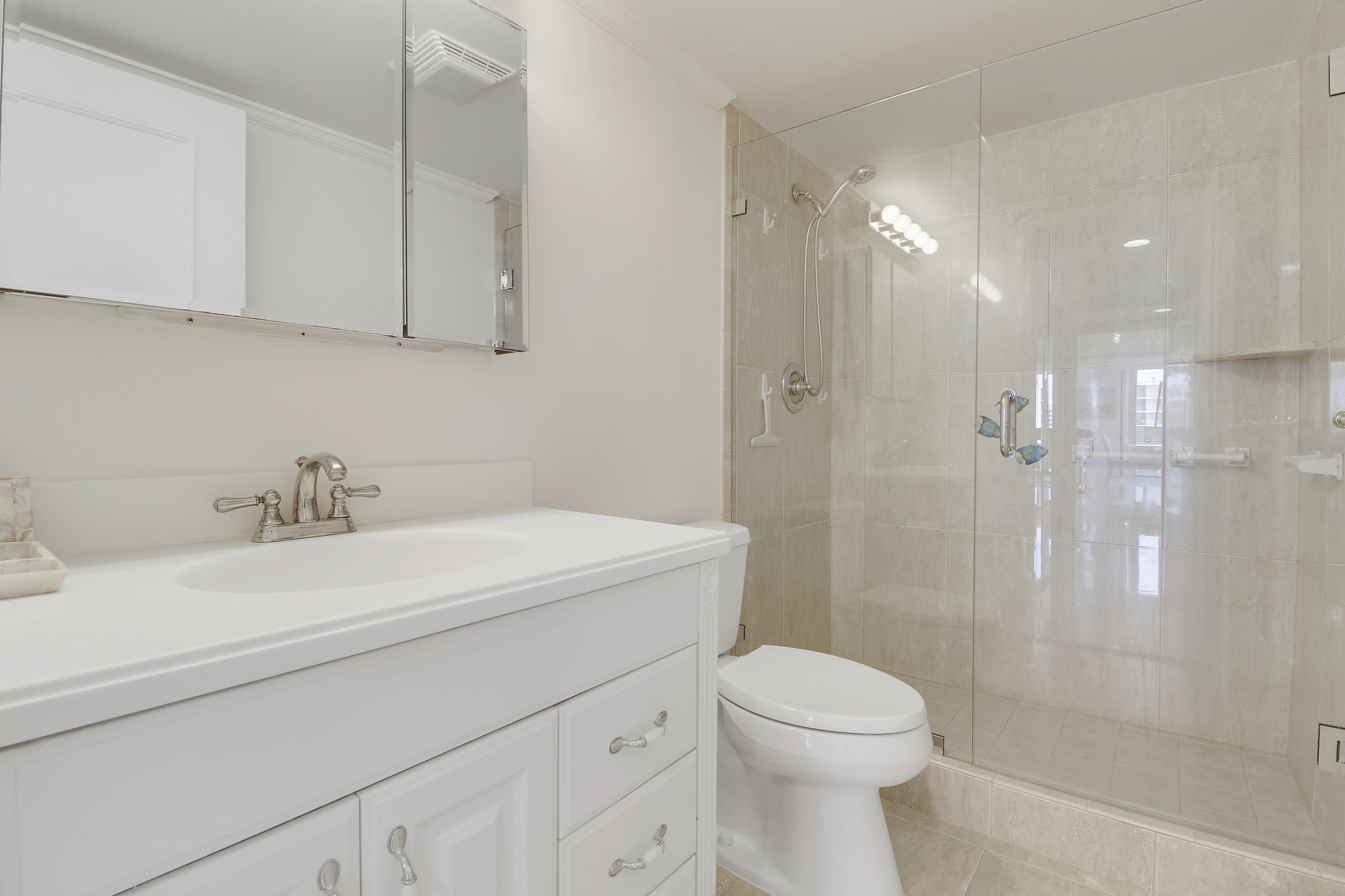 5380 North Ocean Drive, Unit 22J Riviera Beach, FL 33404 - Photo 32 of 53 a bathroom with a sink a toilet and shower
