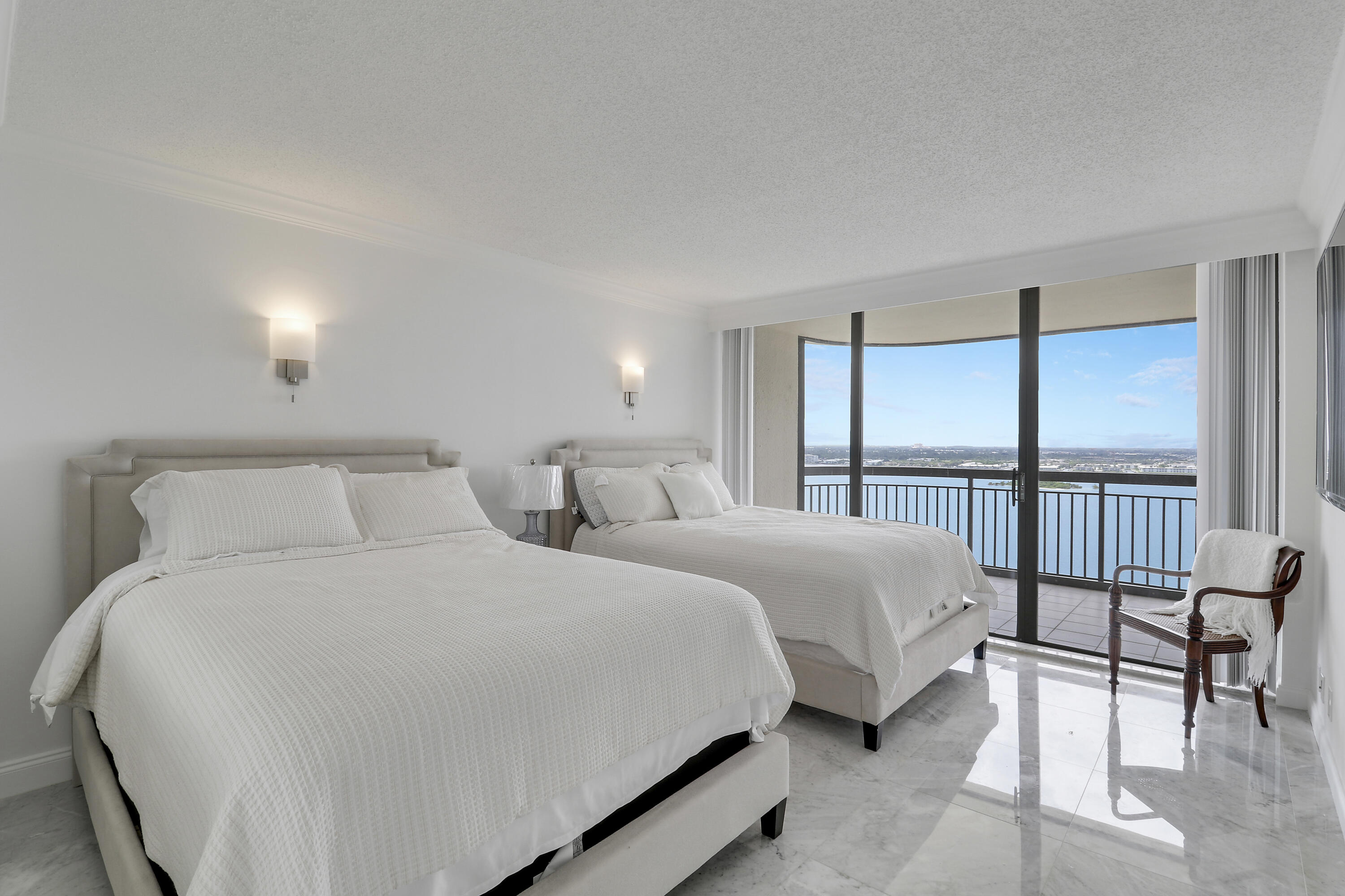 5380 North Ocean Drive, Unit 22J Riviera Beach, FL 33404 - Photo 33 of 53 a large white bed in a hotel room next to a window