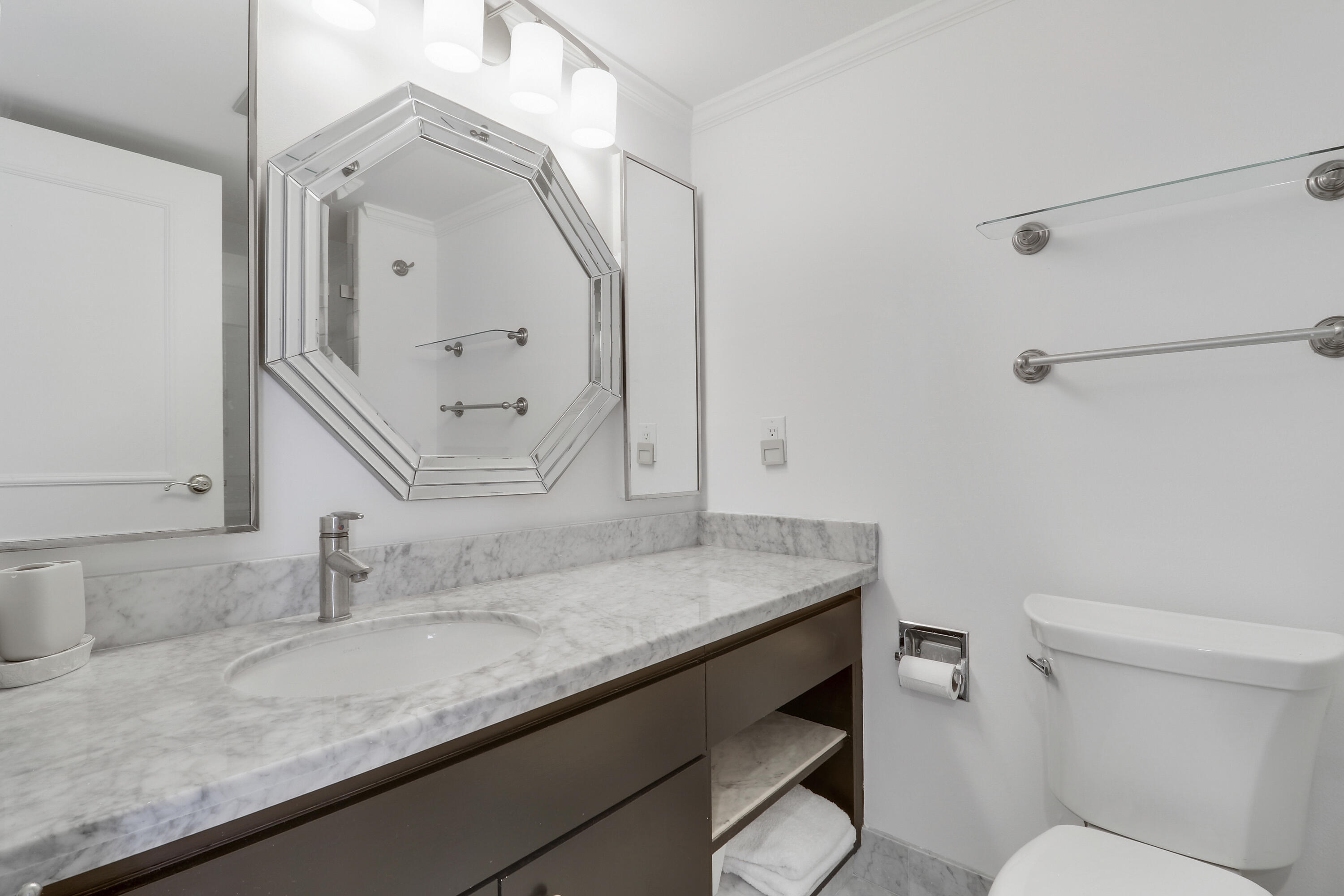 5380 North Ocean Drive, Unit 22J Riviera Beach, FL 33404 - Photo 34 of 53 a bathroom with a granite countertop sink a toilet and mirror