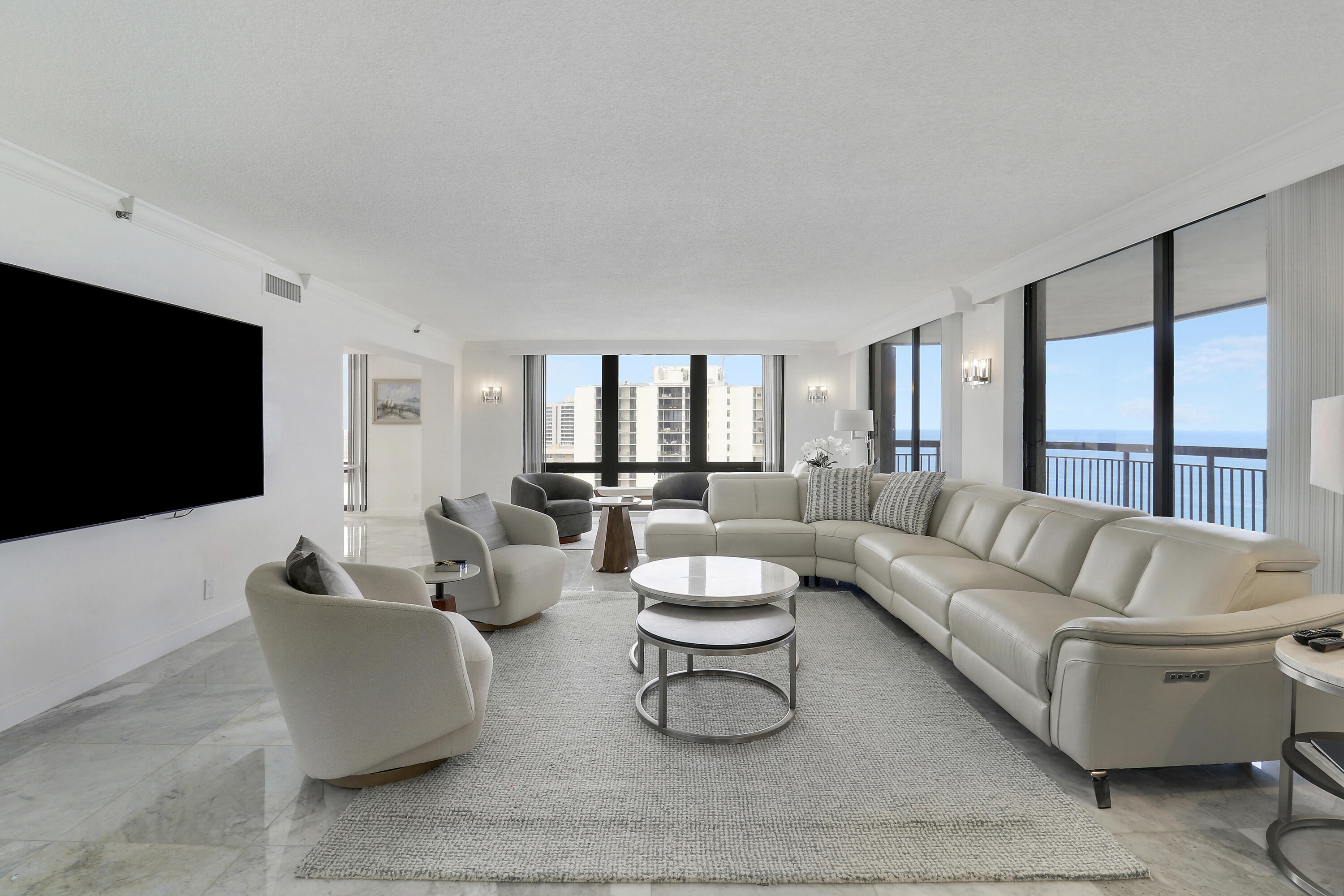 5380 North Ocean Drive, Unit 22J Riviera Beach, FL 33404 - Photo 5 of 53 a living room with furniture and a flat screen tv