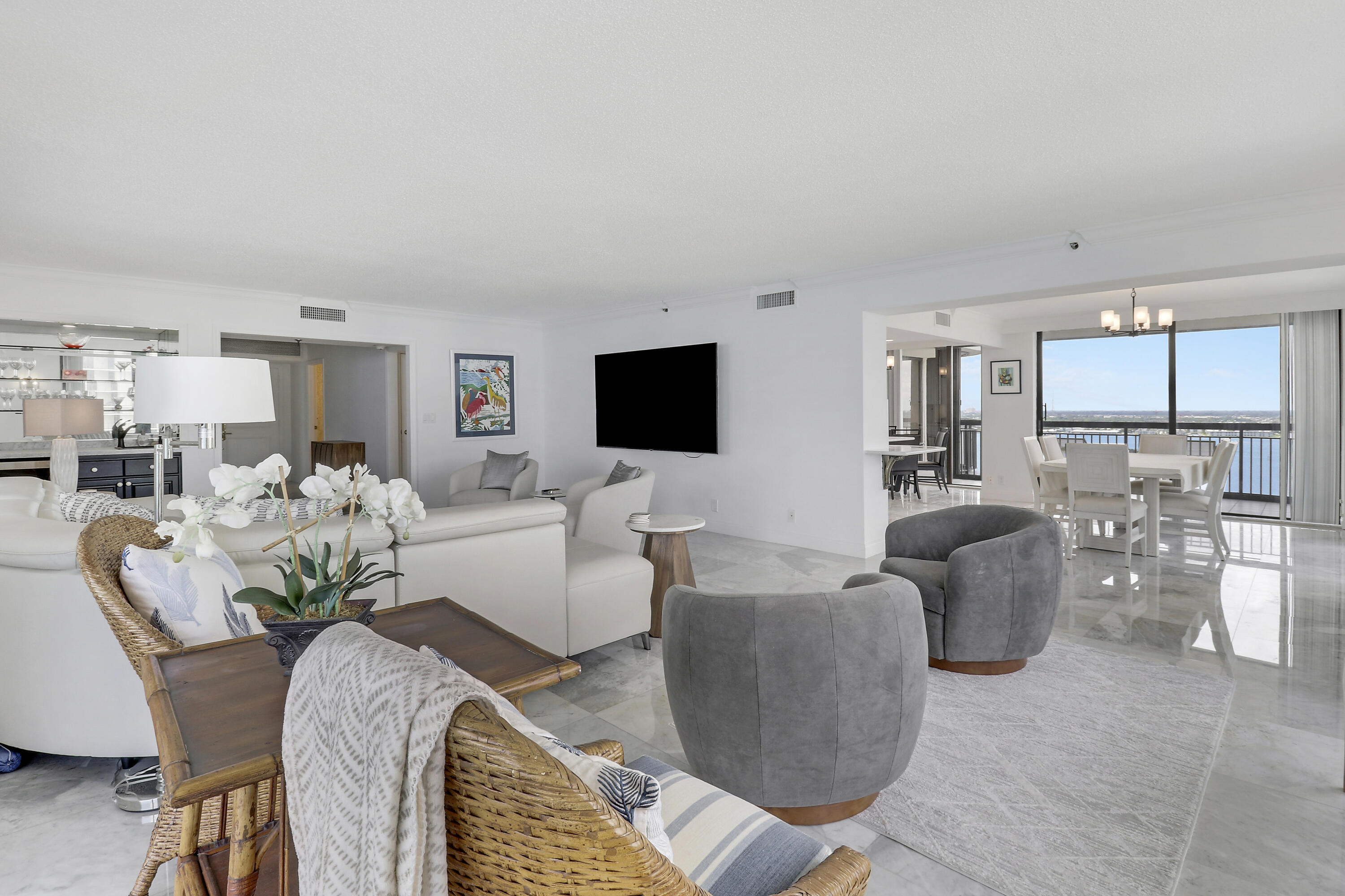 5380 North Ocean Drive, Unit 22J Riviera Beach, FL 33404 - Photo 10 of 53 a living room with furniture dining table and a flat screen tv