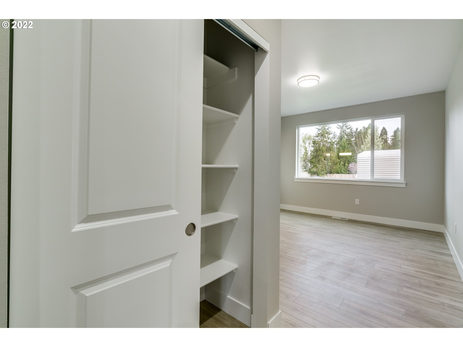 7975 Southwest Oleson Road Portland, OR 97223 - Photo 20 of 32 a view of an empty room with wooden floor and a window