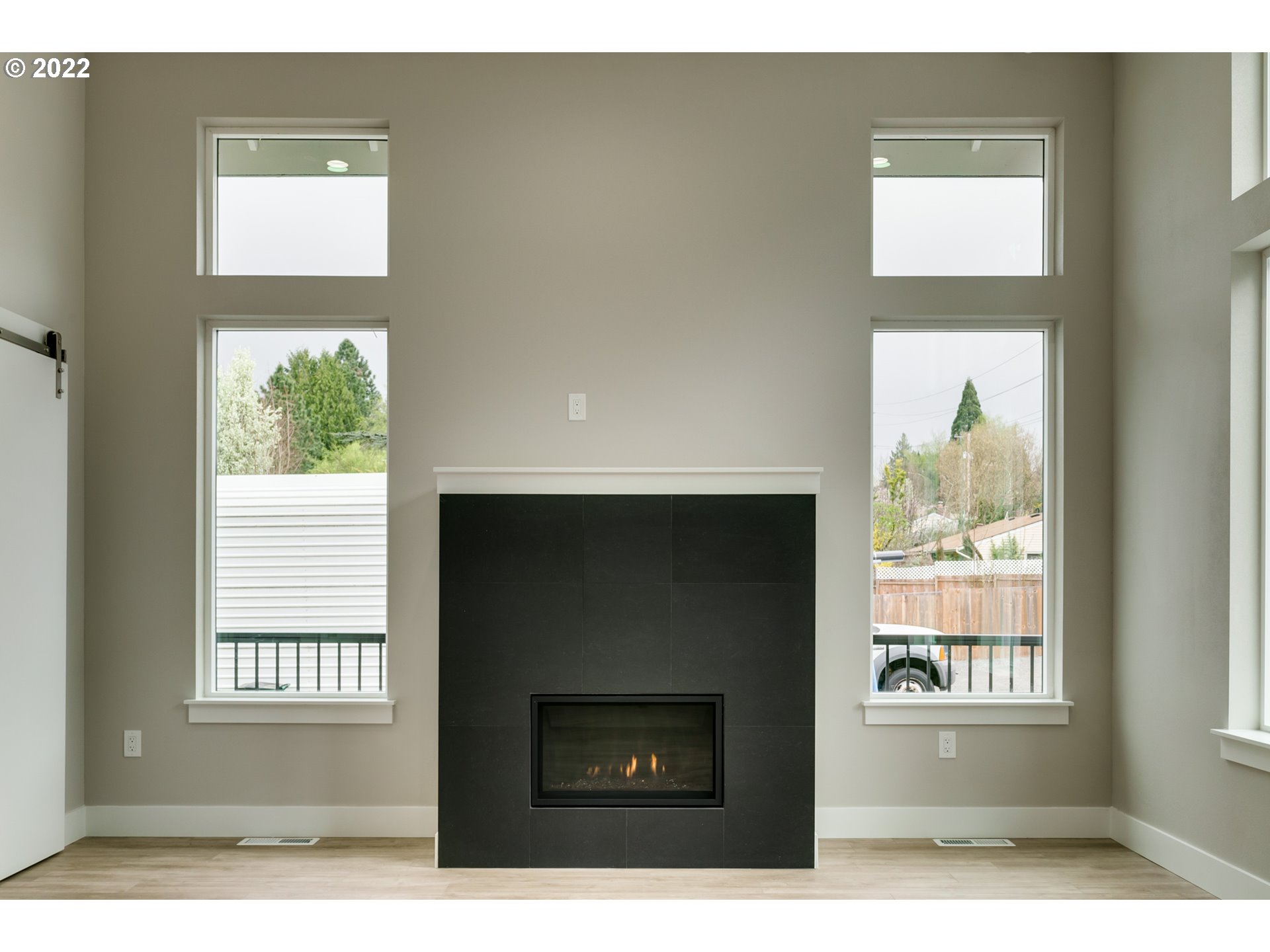 7975 Southwest Oleson Road Portland, OR 97223 - Photo 5 of 32 a living room with a fireplace and a window