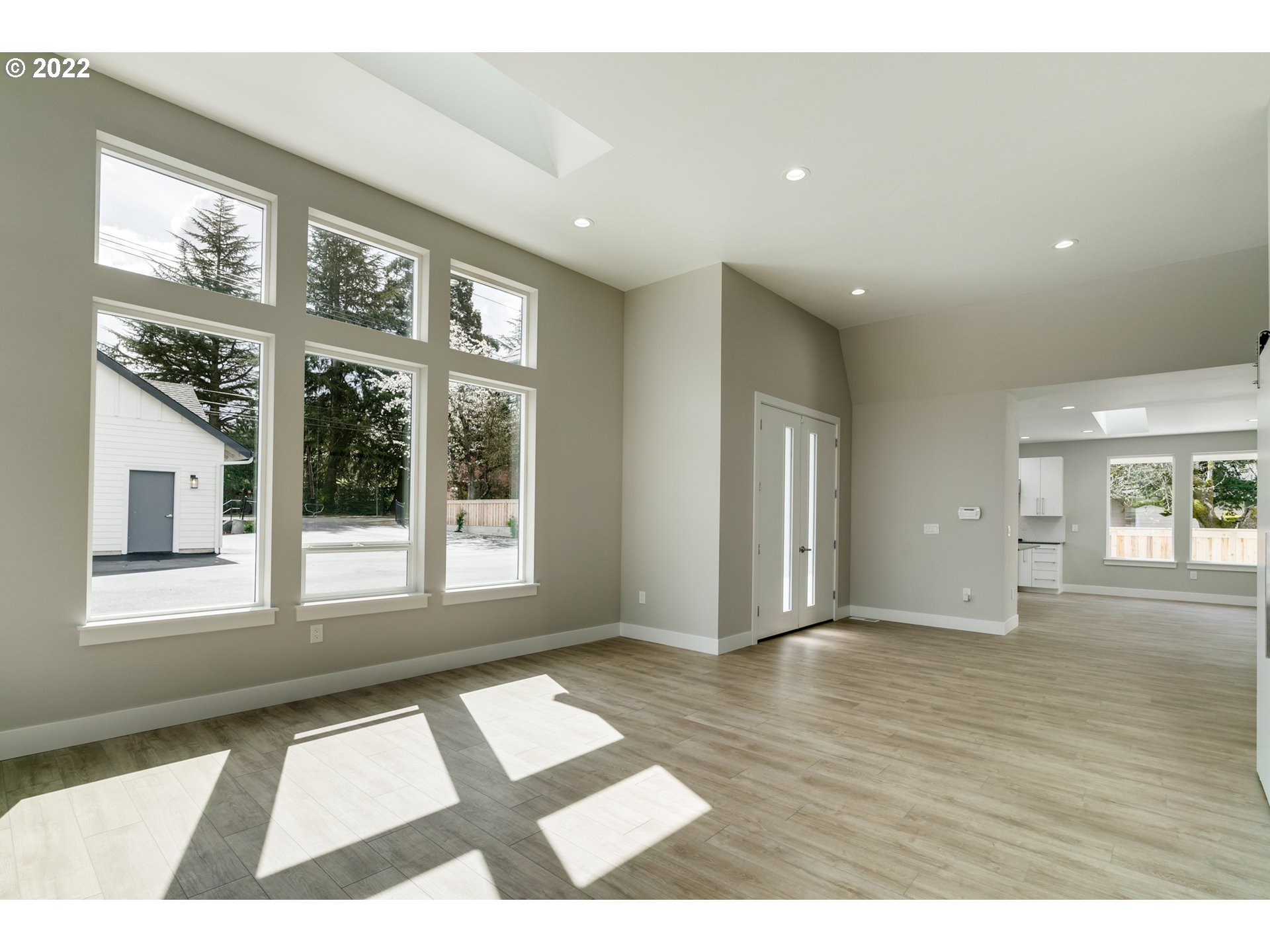 7975 Southwest Oleson Road Portland, OR 97223 - Photo 6 of 32 a view of an empty room with a window and wooden floor