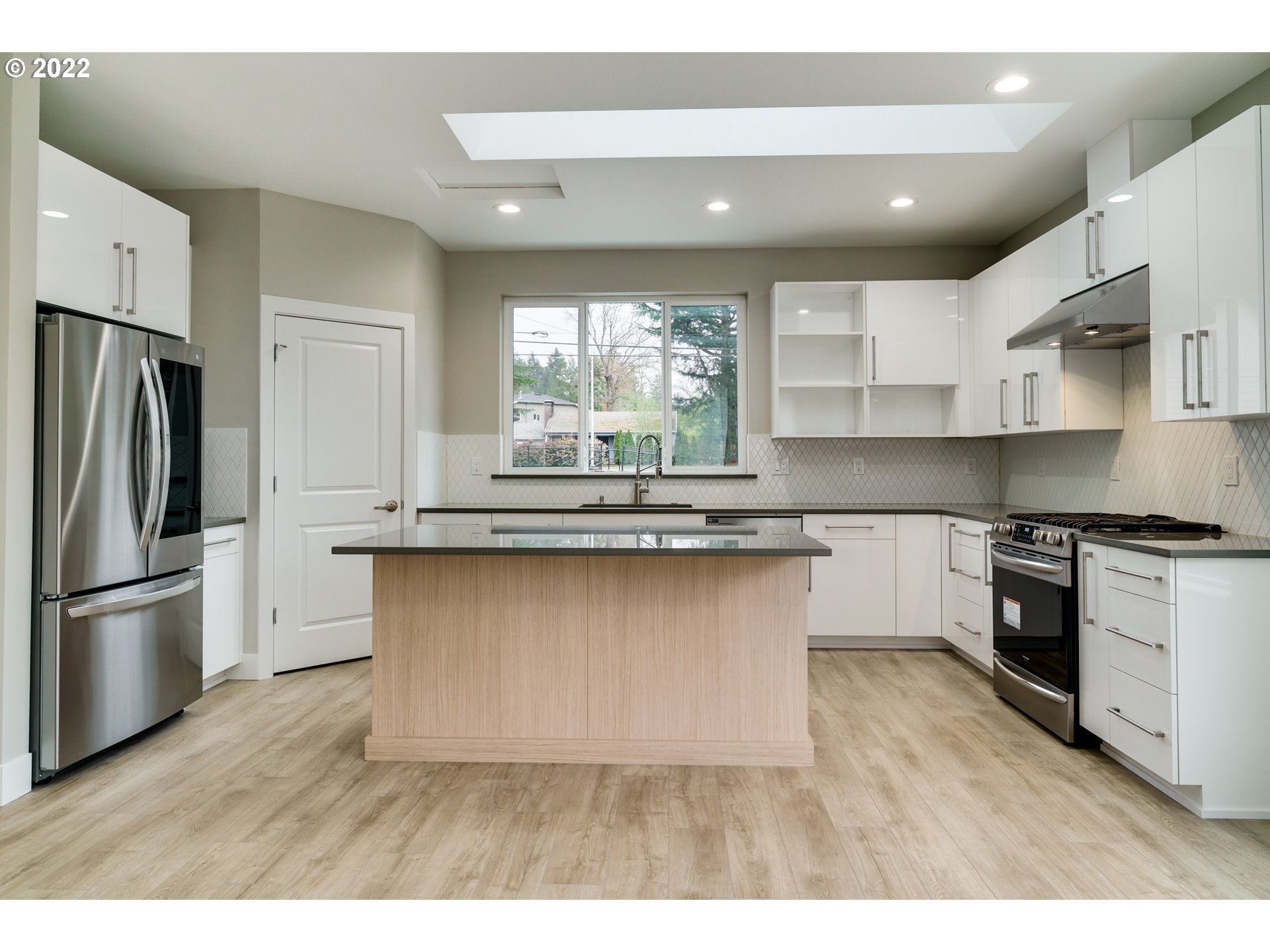 7975 Southwest Oleson Road Portland, OR 97223 - Photo 10 of 32 a kitchen with stainless steel appliances granite countertop a refrigerator and a stove top oven